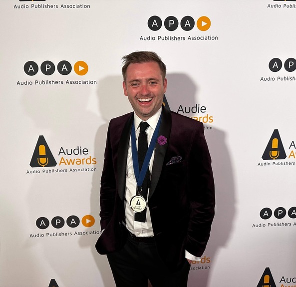 British voiceover Liam Gerrard at awards show on red carpet.